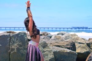 Girl belly dancing on the beach