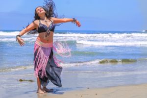 Girl belly dancing on the beach